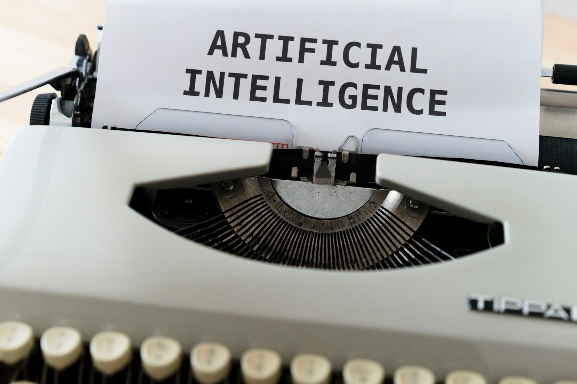 white-and-black-typewriter-with-white-printer-paper-artificial-intelligence